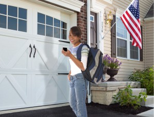 Young girl using a garage door opener remote