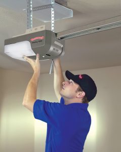 Overhead Door installer putting up a garage door opener.